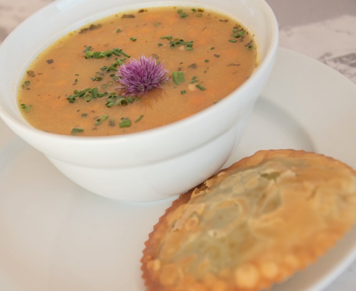 Una delle tante vetrate viste dall'esterno. Lo sguardo passa in parte attraverso di essa e si posa sul massiccio paesaggio montano delle Dolomiti.