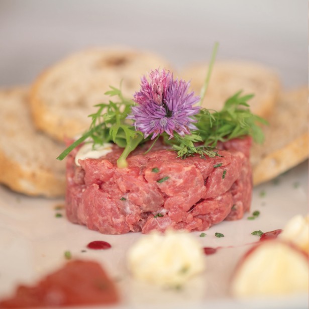 Un piatto di tartare di manzo e pane croccante, servito in modo invitante.